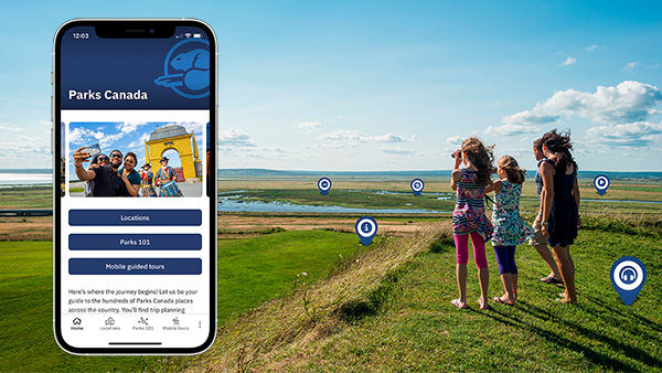 An image of the Parks Canada App on a phone superimposed on a photo of two children take in the landscape at Fort Beauséjour – Fort Cumberland National Historic site, New Brunswick